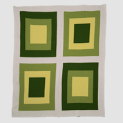 The Bauhaus Throw Blanket by in2green features a two-by-two grid of four square patterns in green and yellow on a light background, crafted from recycled cotton.