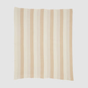 The Herringbone Hues Throw Blanket by In2Green is an eco-friendly creation made from recycled cotton, showcasing a square design with alternating vertical beige and tan stripes on a light background, proudly made in the USA.