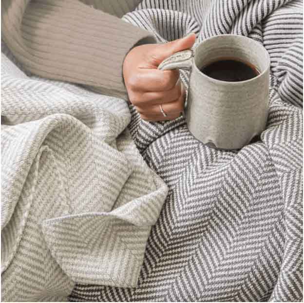 Wool herringbone blankets in light and dark grey.