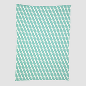 The Poly Juki Throw Blanket by Petra Kaksonen from in2green is a rectangular teal blanket made of recycled polyester yarn, showcasing a Scandinavian design with an enchanting pattern of white penguin silhouettes.