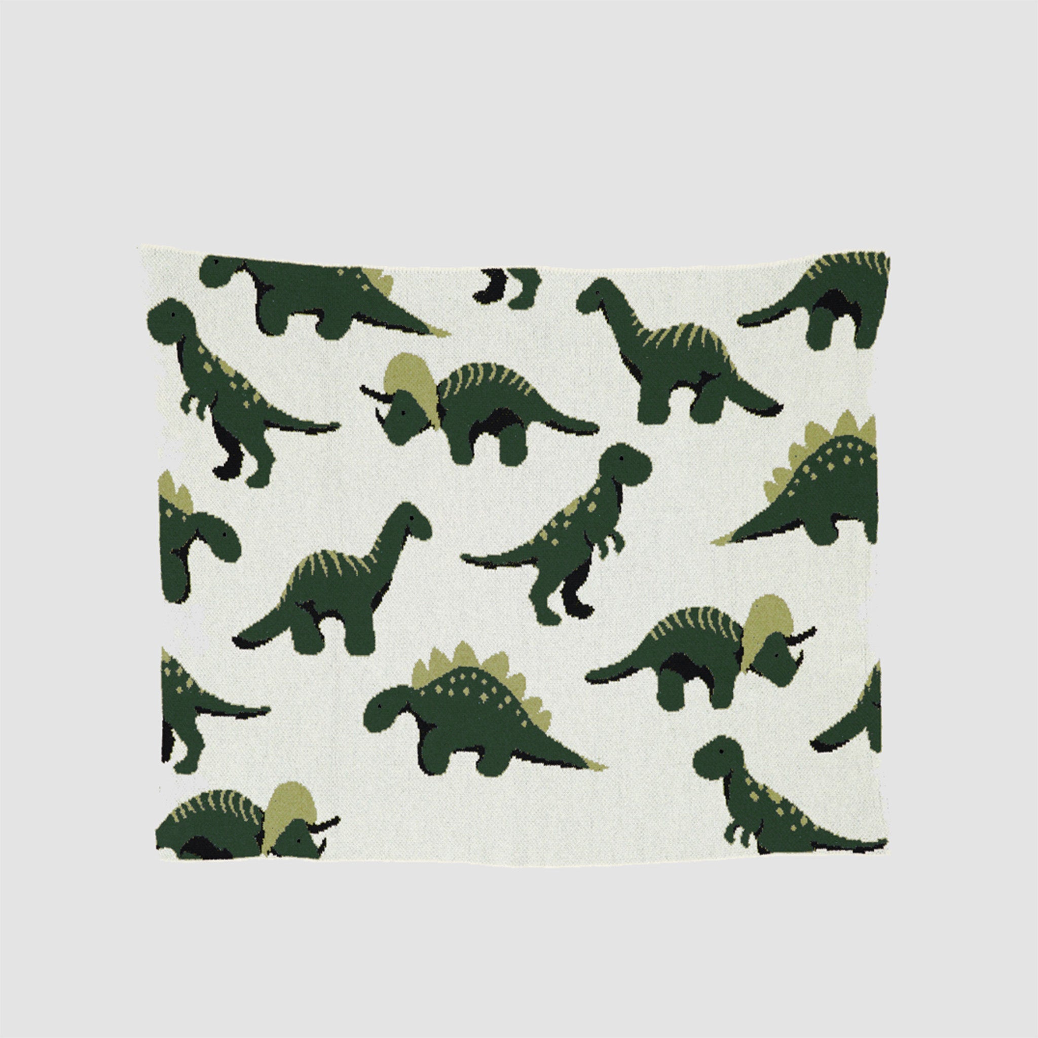 The in2green Baby Dinosaur Blanket is a charming, playful piece with green dinosaurs, including stegosauruses and brachiosauruses, plus a dash of T-Rex magic on a crisp white background.