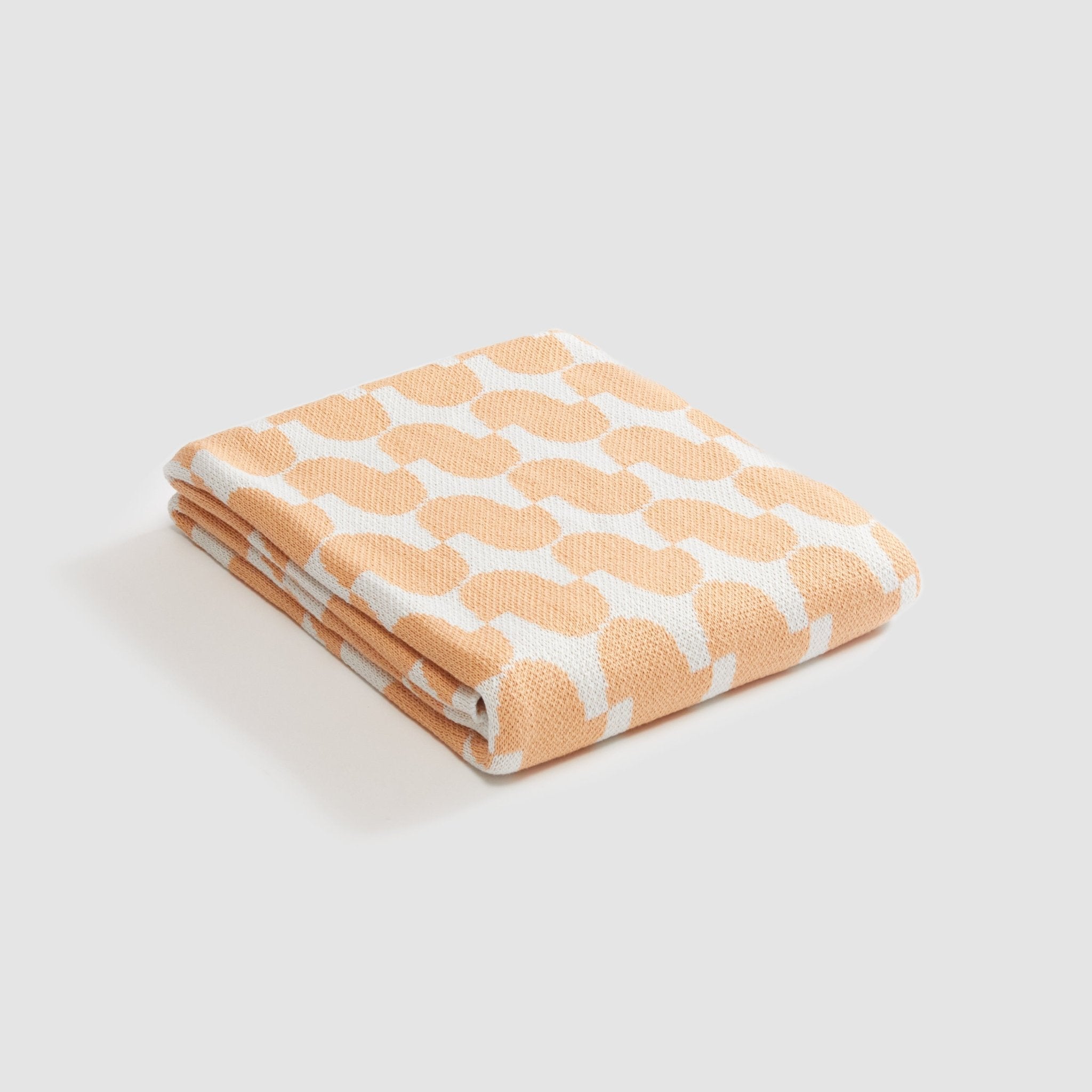 The Poly Juki Throw Blanket by Petra Kaksonen from in2green, adorned with Scandinavian beige and white patterns, brings elegance to any space. Crafted from recycled polyester, it embodies eco-friendly design without sacrificing style.