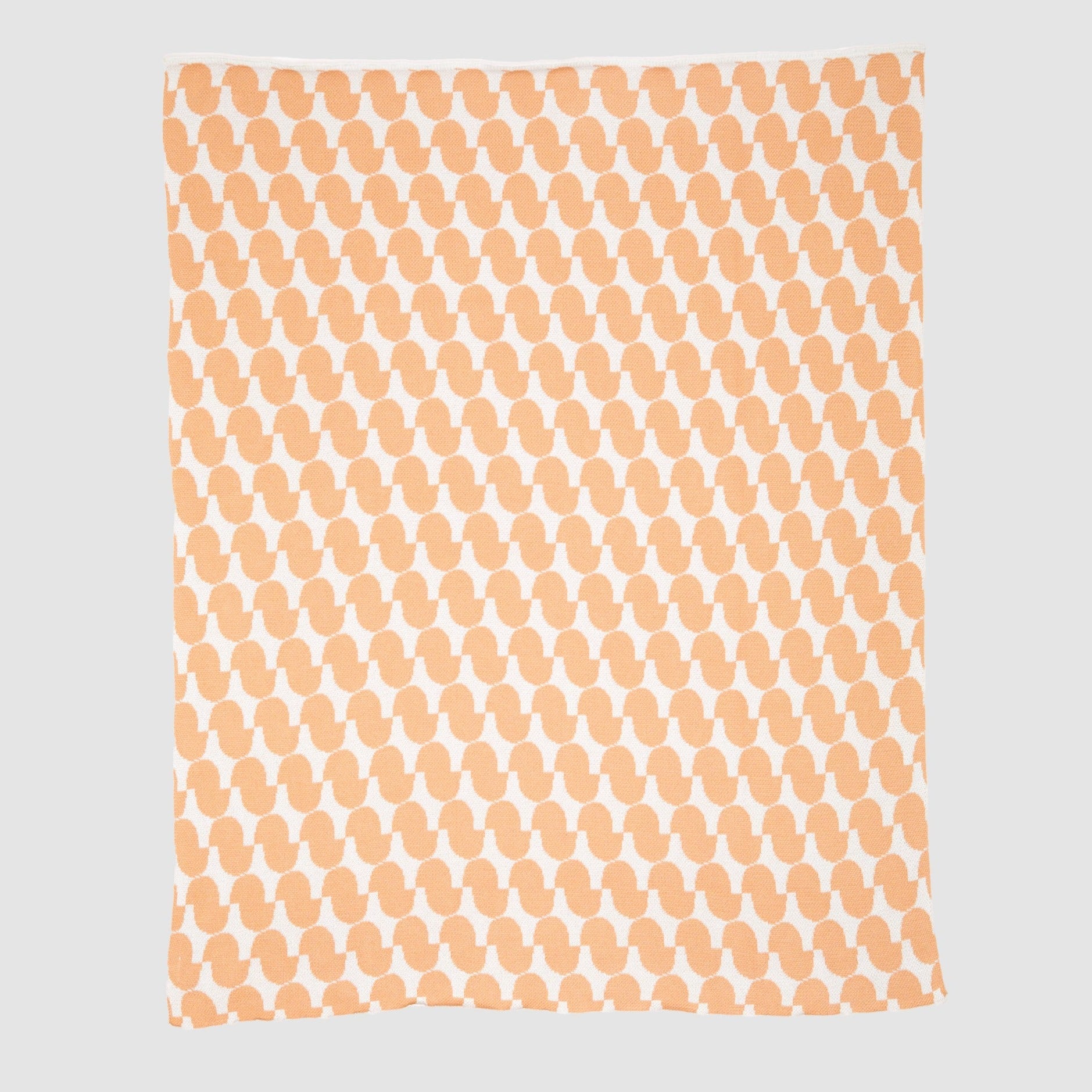 The Poly Juki Throw Blanket by Petra Kaksonen from in2green features an orange and white abstract pattern made from recycled polyester, displayed on a plain background.